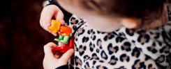 girl holding plastic toys in macro photography